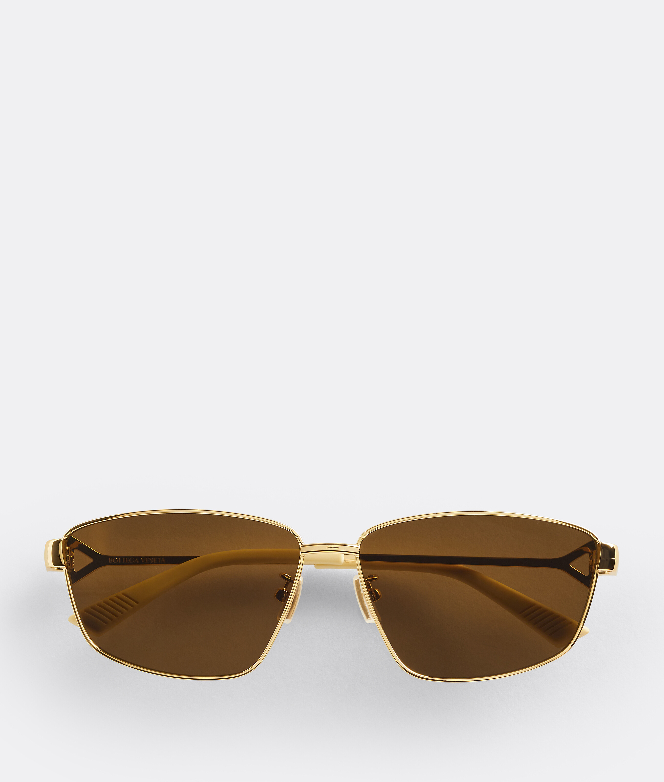 Bottega Veneta® Turn Square Sunglasses in Gold / Brown. Shop online now.