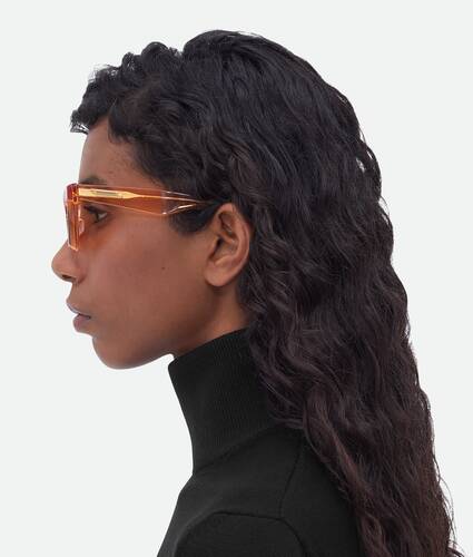 Bottega Veneta® Turn Cat-Eye Sunglasses in Gold / Brown. Shop online now.