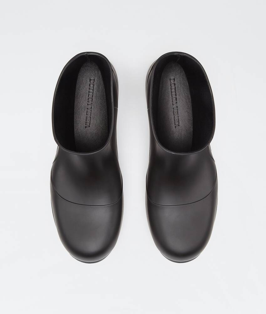 Bottega Veneta® Men's Puddle Ankle Boot in Black. Shop online now.