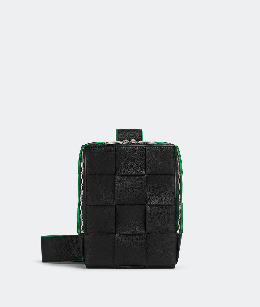 Bottega Veneta® Cassette Sling Bag in Black / Parakeet. Shop online now.