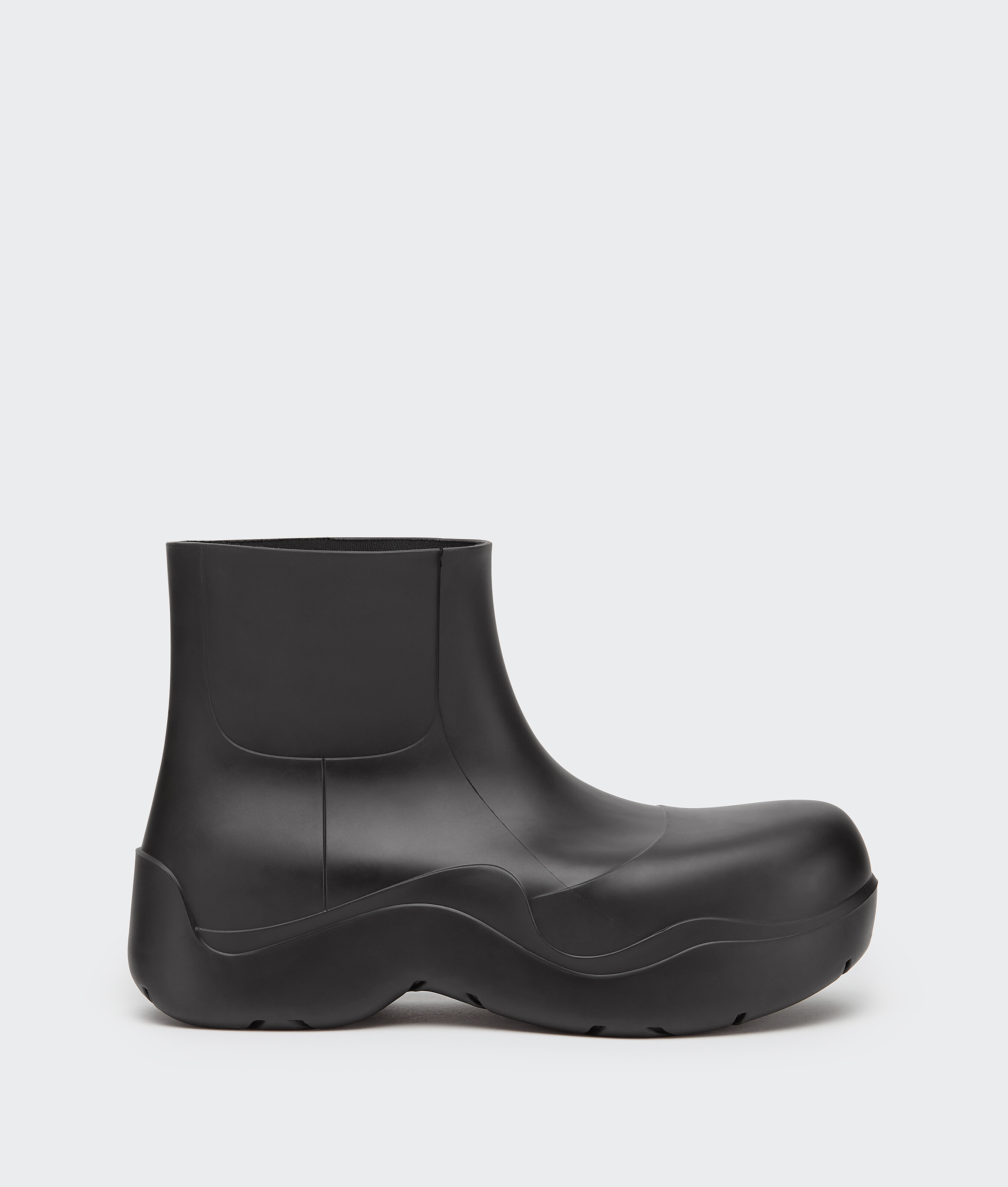 Bottega Veneta® Men's Puddle Ankle Boot in Black. Shop online now.